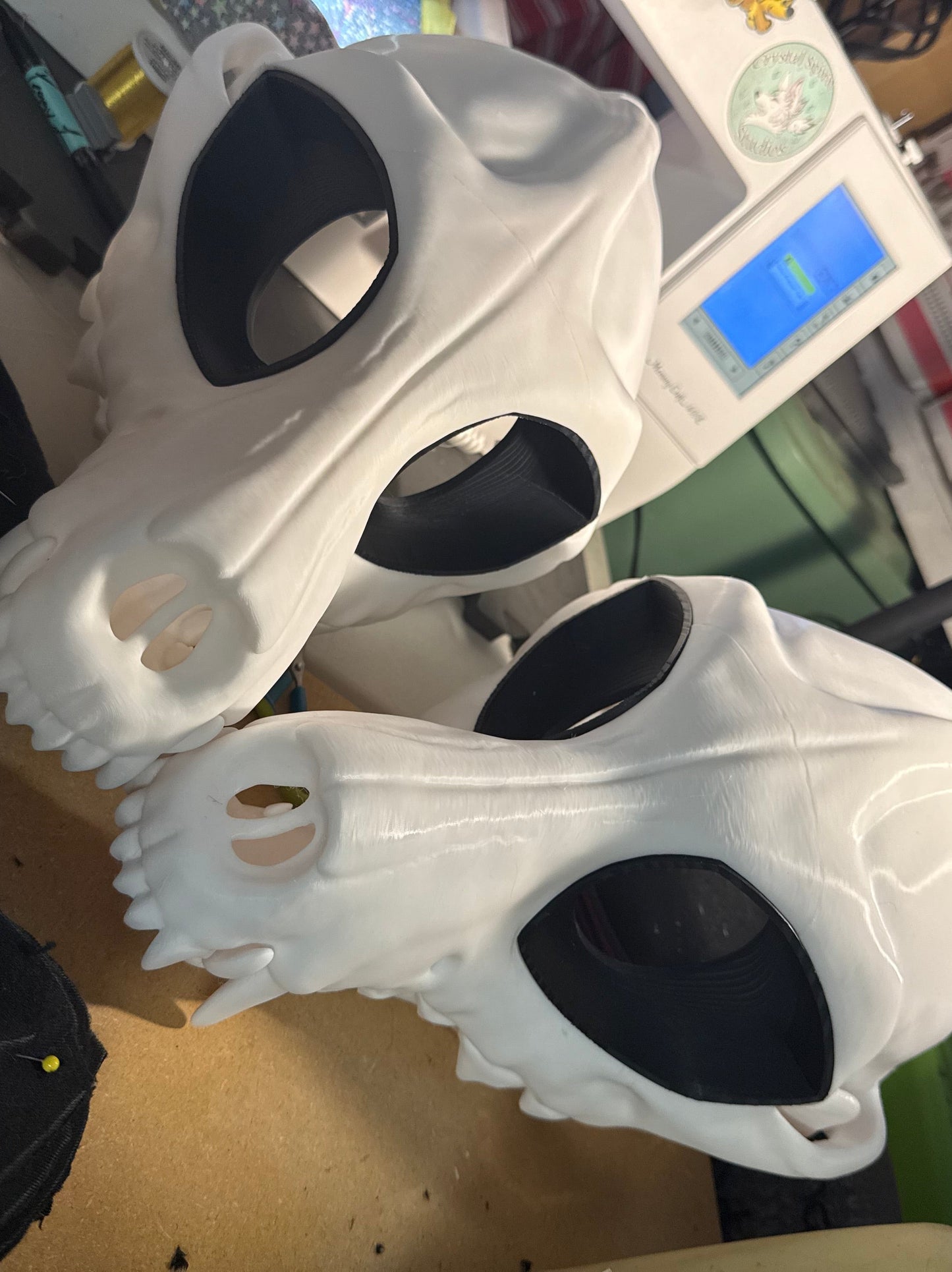 Photo of two skull canines with black eyes on table